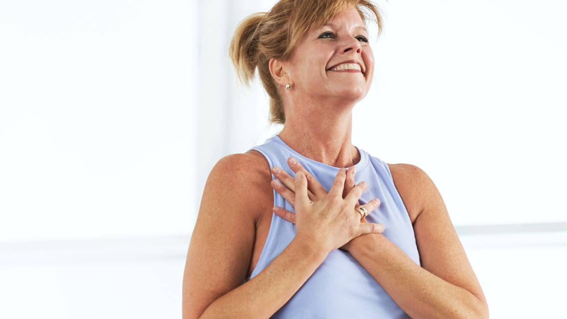 picture of woman with arms folded across chest smiling and happy